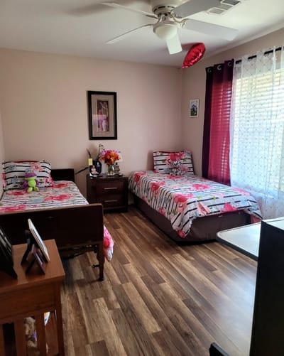Cozy resident room with floral bedding and decorations