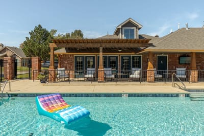 Outdoor pool area with seating and colorful float