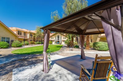 Outdoor gazebo area with landscaped grounds and building view
