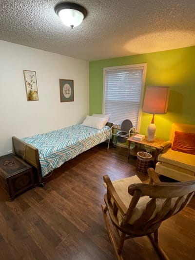 Comfortable private resident room with a bed and seating area