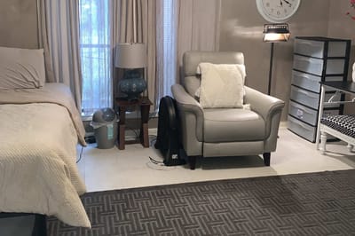 Cozy resident room with a bed and armchair