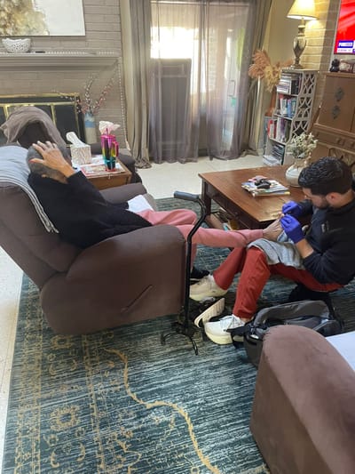Resident receiving care in a cozy living room setting