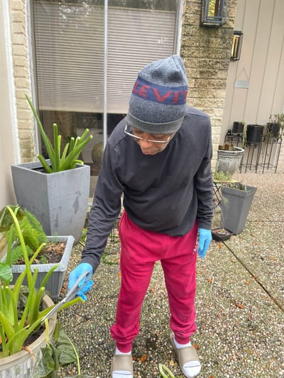 A resident gardening outside near the facility