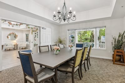 Bright dining room with a large table and floral decor