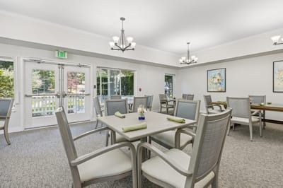 Dining area with tables and chairs in a bright space