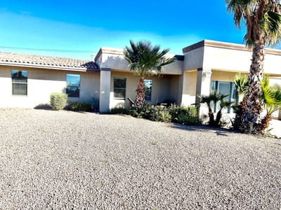 Exterior view of the Rainbow House facility with palm trees