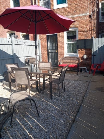 Outdoor patio area with chairs and umbrella