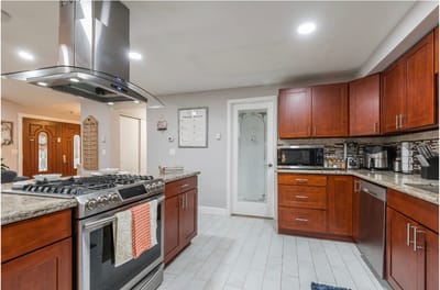 Modern kitchen space with wood cabinets and stainless steel appliances