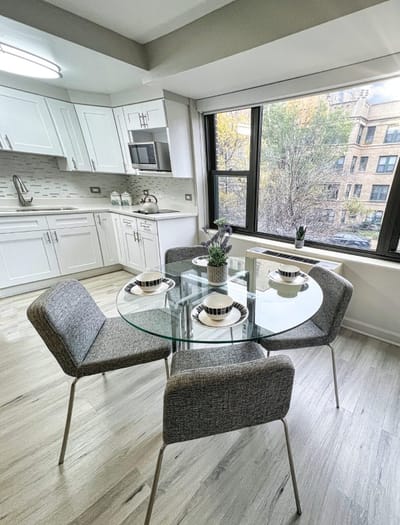Modern dining area with a glass table and chairs