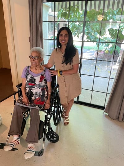 Resident and staff smiling in a common area