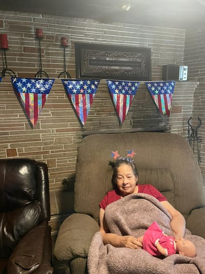 Resident celebrating with decorations in a cozy setting.