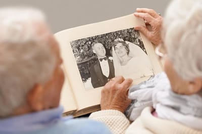 Elderly couple looking at a wedding photo