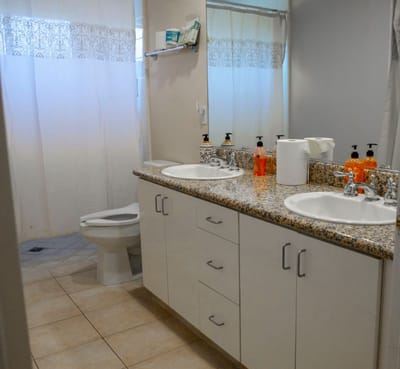 Clean bathroom with dual sinks and a toilet