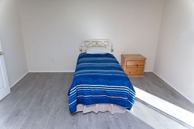 Simple room with a single bed and nightstand