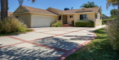 Exterior view of a residential facility with driveway and landscaping