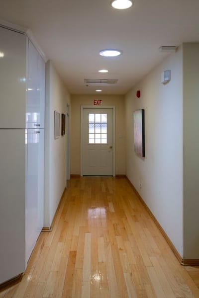 Interior hallway with wooden flooring and exit door