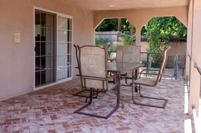 Outdoor seating area with a table and chairs.