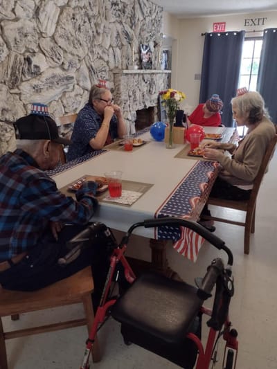 Residents enjoying a meal together in a dining room.