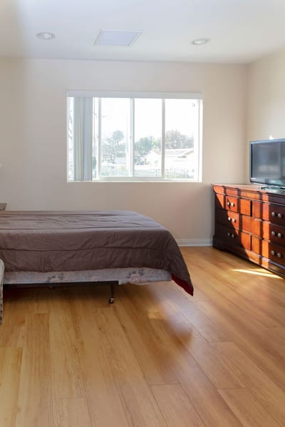 Cozy resident bedroom with wooden furniture.