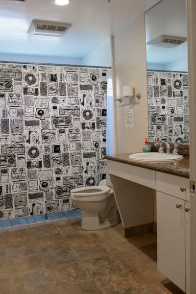 Clean bathroom with decorative shower curtain