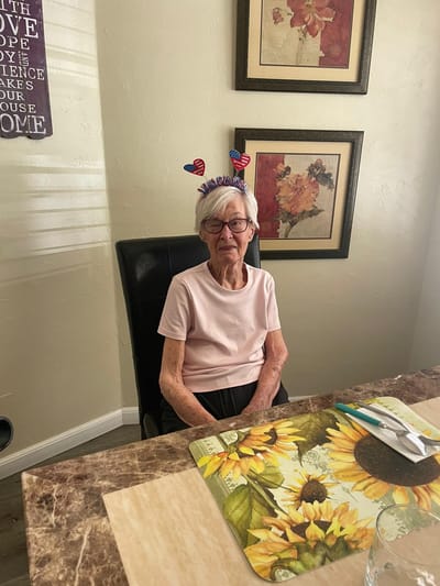 Senior woman with festive headband at a table