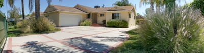 Front exterior of a residential building with landscaping.