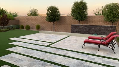 Outdoor patio with loungers and landscaped area