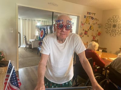 Resident celebrating with festive glasses.