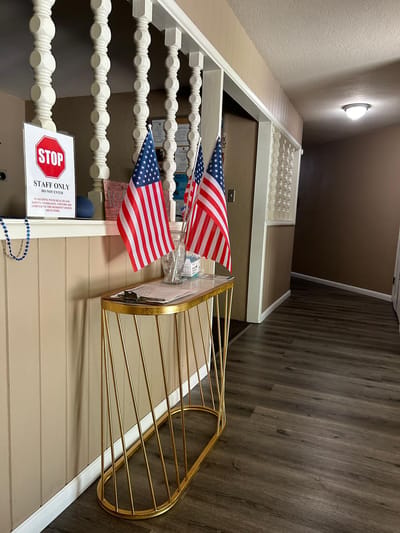 Interior hallway with flags and a decorative table