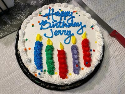 Birthday cake with colorful candles and message