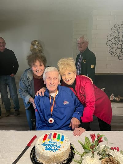 Residents celebrating with a birthday cake