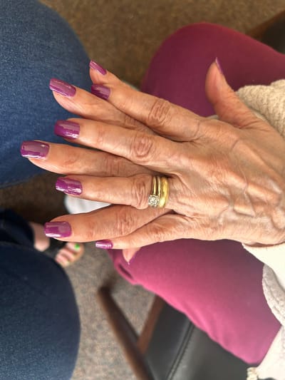 Close-up of a woman's hands with colorful nails.