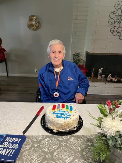 Resident celebrating birthday with cake.