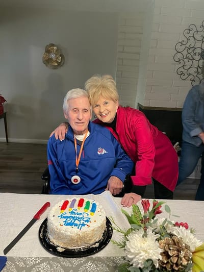 Resident celebrating with cake at a gathering.