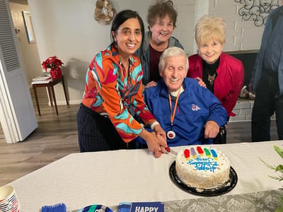 Residents celebrating with cake at a common area.