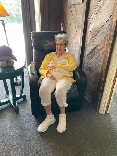 Senior resident relaxing in a common area.