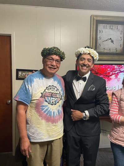 Two residents celebrating with floral headpieces.