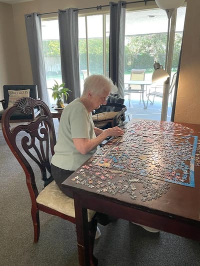 Resident working on a puzzle indoors.