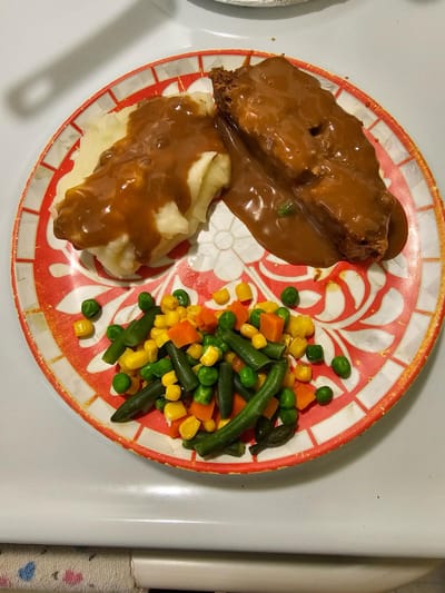 Plate of meatloaf with mashed potatoes and vegetables