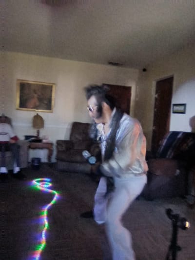 Resident enjoying a performance indoors.