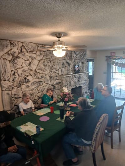 Residents engaged in an activity at a table.