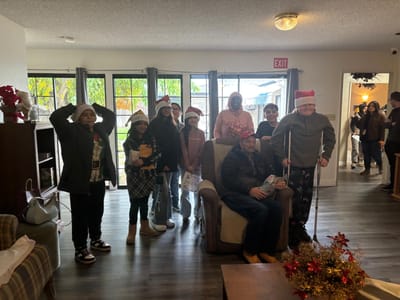 Residents and visitors celebrating with holiday hats.
