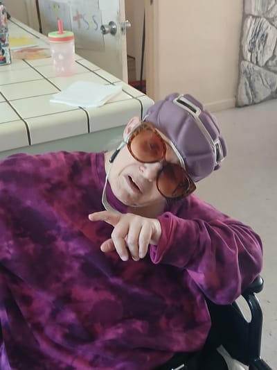 Resident enjoying a fun moment with sunglasses.