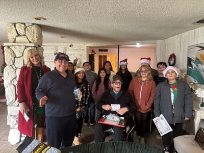 Group of residents and staff celebrating together indoors