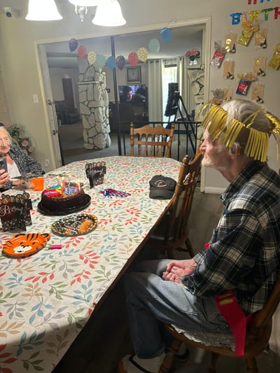Residents celebrating a birthday party with cake.