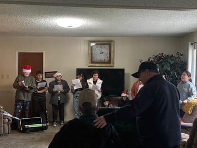 Residents enjoying a holiday singing event.