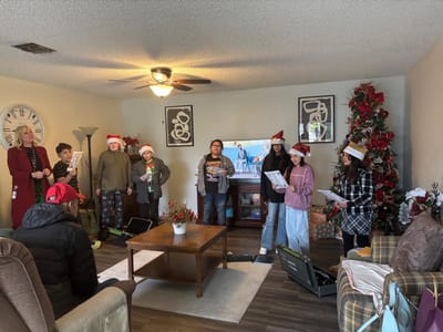 Residents singing carols during a holiday event.