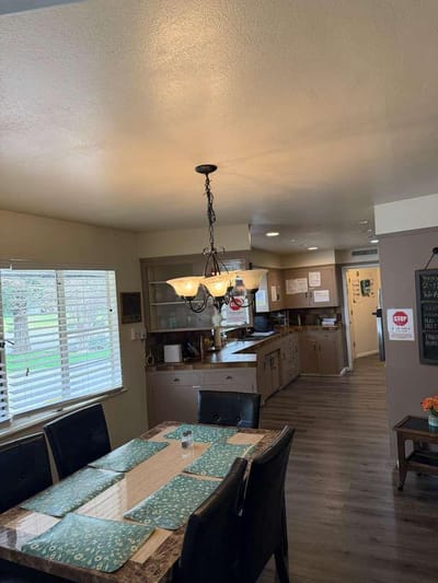 Bright common area with a kitchen and dining table.