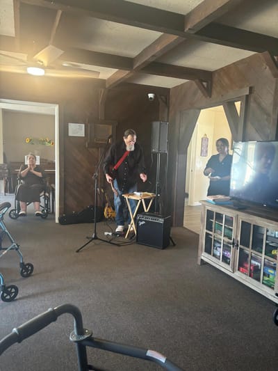Residents enjoying live music in a common area.
