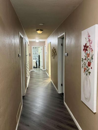 Interior hallway with floral decor and doors.